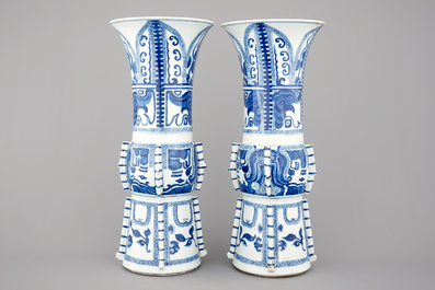An unusual pair of tall Chinese blue and white porcelain gu-shaped vases, Kangxi, ca. 1700