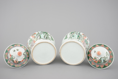 A pair of Chinese famille verte porcelain baluster vases and covers, 19th C.