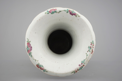 A tall Chinese porcelain famille rose vase with a figural scene and a small Qianjiang type vase, 19th C.