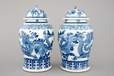 A pair of blue and white Chinese porcelain dragon vases and covers, 19th C.