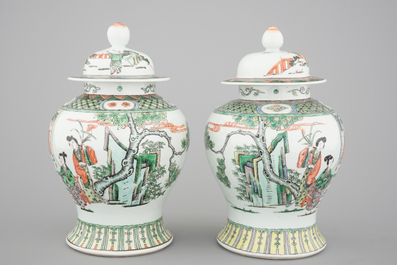 A pair of Chinese famille verte porcelain baluster vases and covers, 19th C.