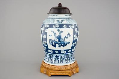 A tall Chinese blue and white porcelain temple jar on gilt wood stand, 19th C.