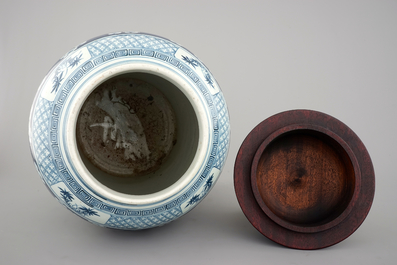 A tall Chinese blue and white porcelain temple jar on gilt wood stand, 19th C.