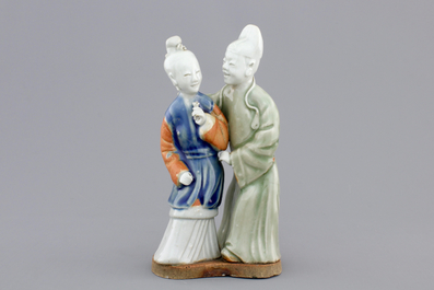 A Chinese celadon and blue-white biscuit group of a couple, Qianlong, 18th C.