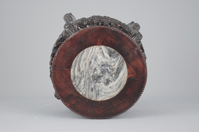 An elaborately carved Chinese hardwood vase stand with dreamstone insert, 19th C.