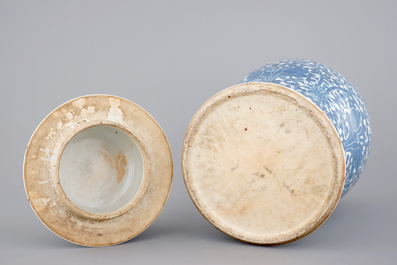 A tall blue and white Chinese porcelain vase and cover with lotus scrolls, 19th C.