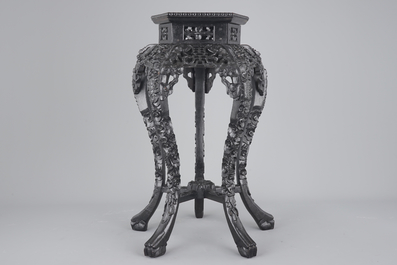 An intricately carved Chinese hardwood marble top vase stand, 19th C.