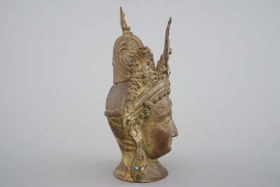 A tall gilt bronze head of a Boddhisatva with semi-precious stones, Tibet, 17/18th C.