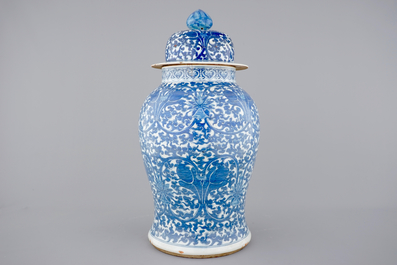 A tall blue and white Chinese porcelain vase and cover with lotus scrolls, 19th C.