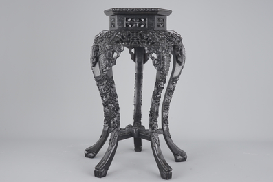 An intricately carved Chinese hardwood marble top vase stand, 19th C.