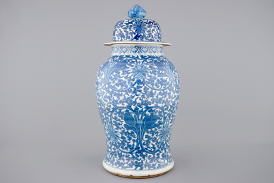 A tall blue and white Chinese porcelain vase and cover with lotus scrolls, 19th C.