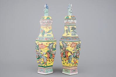 A pair of rare hexagonal Chinese famille jaune porcelain vases with figural covers, 19th C.