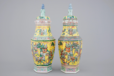 A pair of rare hexagonal Chinese famille jaune porcelain vases with figural covers, 19th C.