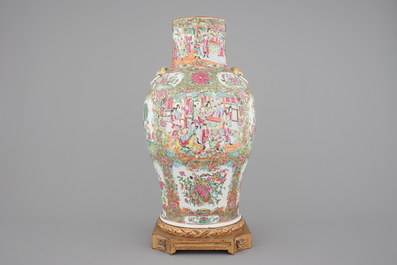 A tall Chinese Canton rose medallion porcelain vase on gilt wood stand, 19th C.