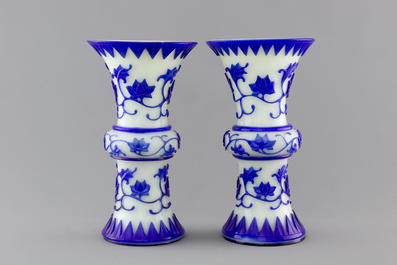 A pair of blue and white Chinese Peking overlay glass yenyen vases, early 20th C.