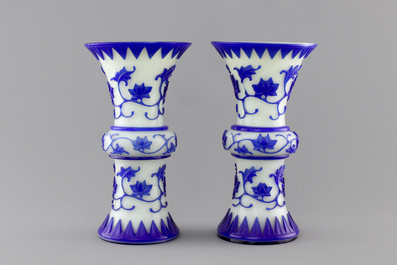 A pair of blue and white Chinese Peking overlay glass yenyen vases, early 20th C.