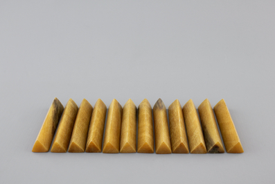 A set of 12 rare polished rhinoceros horn knife rests, ca. 1900