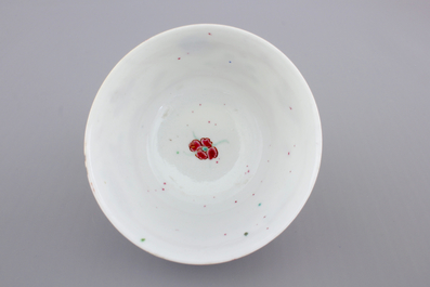 A Chinese porcelain famille rose cup and saucer with insects encircling a rose, Yongzheng-Qianlong, 18th C.