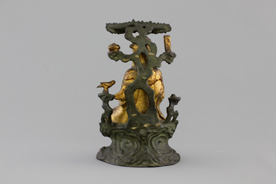 A Chinese bronze and gilt Buddha with child, seated beneath a bodhi tree, 17/18th C.