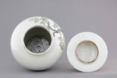 A Chinese famille rose porcelain vase with playing boys on a wooden stand, 19th C.