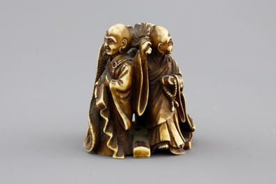 A Japanese patinated ivory netsuke: a dragon amongst sages, 19th C.