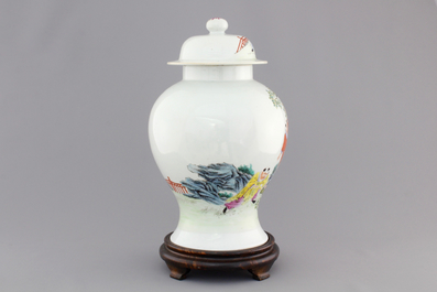 A Chinese famille rose porcelain vase with playing boys on a wooden stand, 19th C.