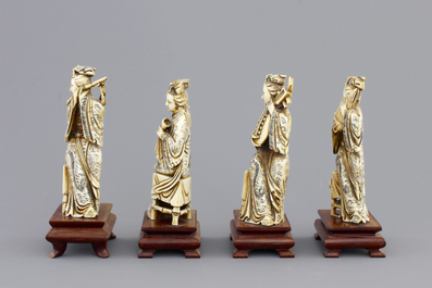 Four Chinese carved ivory ladies with instruments on wooden stands, ca. 1900