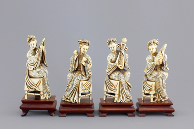 Four Chinese carved ivory ladies with instruments on wooden stands, ca. 1900