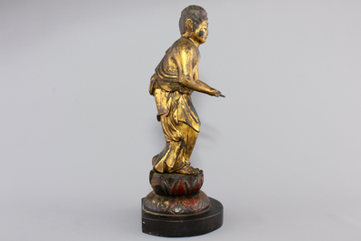 A Chinese gilt and laquered wood figure of a female deity, 18/19th C.