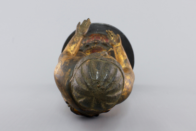 A Chinese gilt and laquered wood figure of a female deity, 18/19th C.
