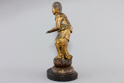 A Chinese gilt and laquered wood figure of a female deity, 18/19th C.