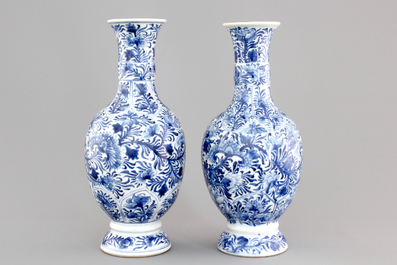 A pair of Chinese porcelain blue and white flower scroll vases, Kangxi, ca. 1700