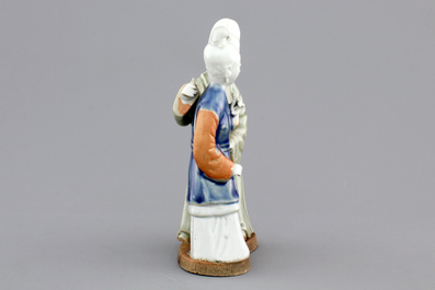 A Chinese celadon and blue-white biscuit group of a couple, Qianlong, 18th C.