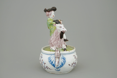 A Dutch Delft polychrome butter tub with a buckrider, 18th C.