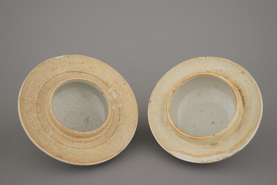 Two Chinese porcelain famille rose jars and covers with scholar's objects, 19th C.