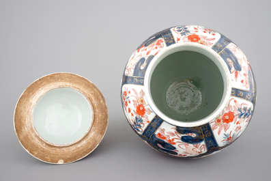 A tall Japanese Imari vase, 17/18th C. and two Chinese famille rose plates, 19th C.