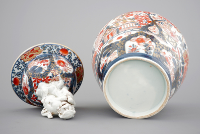 A tall Japanese Imari vase, 17/18th C. and two Chinese famille rose plates, 19th C.