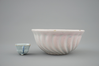 A white Dutch Delft baking mold and a miniature cup, 18th C.