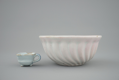 A white Dutch Delft baking mold and a miniature cup, 18th C.