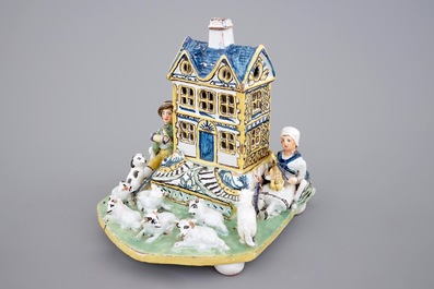 A rare French pottery group with musicians herding sheep by a house, 18th C.