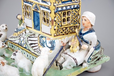 A rare French pottery group with musicians herding sheep by a house, 18th C.
