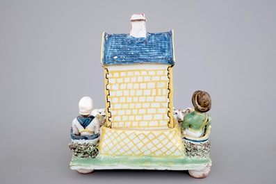 A rare French pottery group with musicians herding sheep by a house, 18th C.