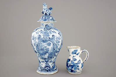A large Dutch Delft blue and white vase and cover, a plate and a cream jug, 18th C.