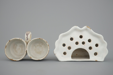 A Dutch Delft strainer, a wall flower holder and a cruet stand in French faience, 18th C.