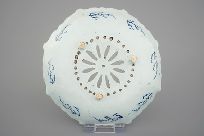 A Dutch Delft strainer, a wall flower holder and a cruet stand in French faience, 18th C.