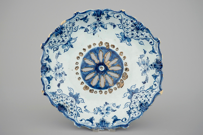 A Dutch Delft strainer, a wall flower holder and a cruet stand in French faience, 18th C.