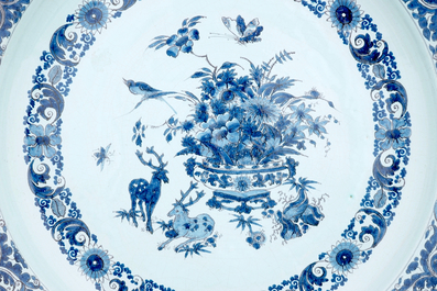 A massive blue and white charger with deer and a flower vase, 17/18th C.