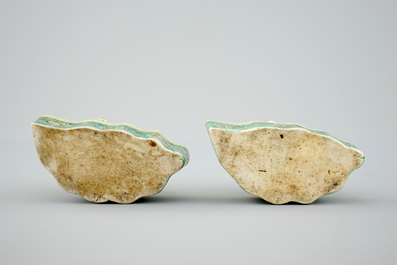 A pair of Chinese verte on biscuit foo dog joss stick holders, Kangxi