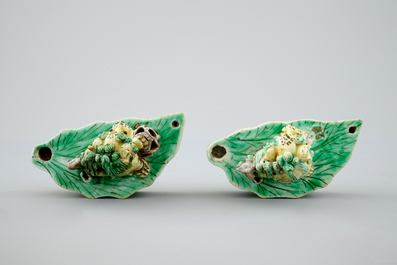A pair of Chinese verte on biscuit foo dog joss stick holders, Kangxi