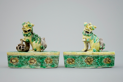 A pair of Chinese verte on biscuit foo dog joss stick holders, Kangxi